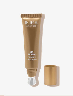 INIKA Tinted Lip Serum i guldfärgad tub med lock bredvid
