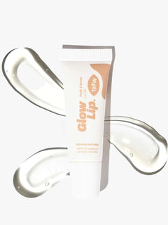 Trew Glow Lip läppolja i tub bredvid genomskinliga klickar