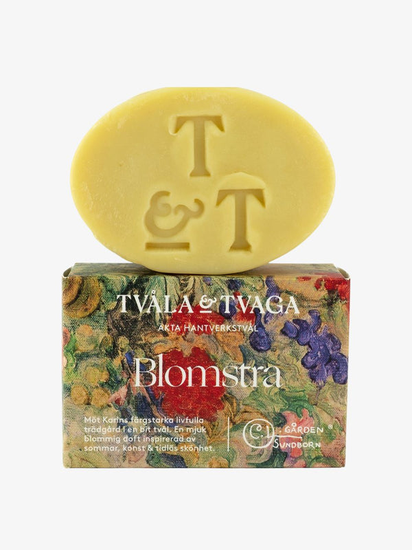 Tvåla & Tvaga tvål Blomstra, gul tvål ovanpå blommig förpackning